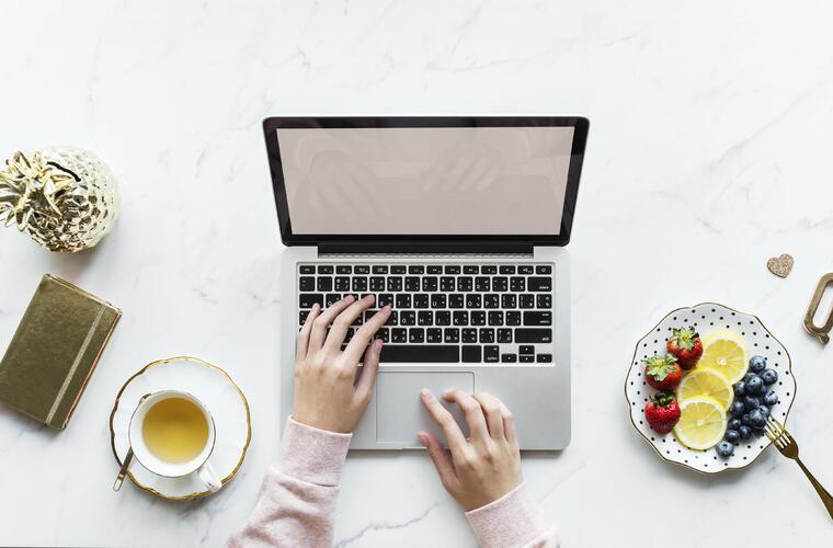 laptop at the table with tea at side