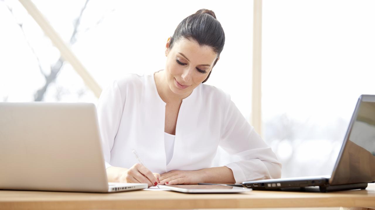 bigstock Businesswoman Working On Lapto 239551429
