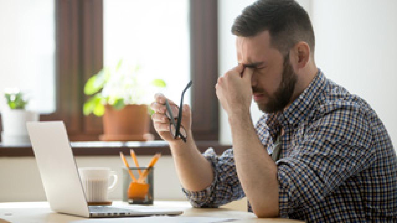 bigstock Tired Stressed Male Worker Tak 241436326